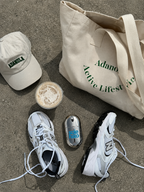 Cooling foot spray beside running shoes, gym tote bag and cap, ready for post-workout recovery
